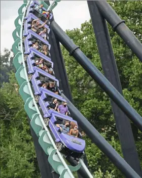  ?? Emily Matthews/Post-Gazette ?? A DIFFERENT ZOOM Kennywood guests react as they ride the Phantom’s Revenge on National Roller Coaster Day on Sunday at Kennywood amusement park in West Mifflin.