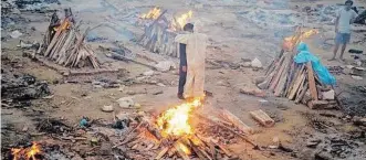  ??  ?? FAMILY members embrace each other amid the burning pyres of victims who lost their lives due to Covid-19 in New Delhi. The second wave of the pandemic poses serious foreign policy challenges to India, says the writer. | AFP