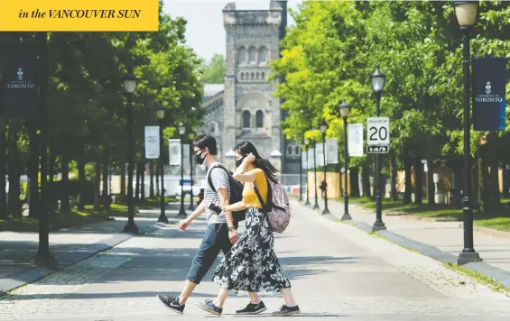  ?? NATHAN DENETTE/THE CANADIAN PRESS ?? People walk past the University of Toronto in June. With the recent surge in COVID-19 cases among young people, many are wondering what the return to campus will be like.