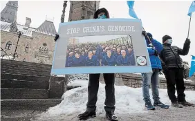  ?? ADRIAN WYLD THE CANADIAN PRESS FILE PHOTO ?? Protesters gather outside the Parliament buildings in Ottawa in February 2021. That year, the Canadian Parliament voted to describe the treatment of the Uyghur people by the Chinese government as a “genocide.”