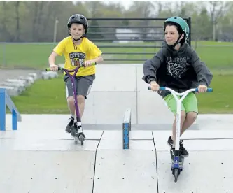  ?? JESSICA NYZNIK/EXAMINER ?? Blake Graham, left, and Brody Graham ride their scooters at the skateboard park in Norwood Park on Friday. The two brothers spoke to Township of Asphodel-Norwood councillor­s earlier this month about getting a newer, larger park for the township....