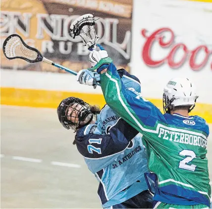  ?? BOB TYMCZYSZYN
TORSTAR FILE PHOTO ?? St. Catharines Athletics’ Saul Van Der Zalm (71) and Peterborou­gh Lakers Tyler Hendrycks get their sticks tied up June 19, 2019. Next year, the Athletics will be hosting the Canadian Minto Cup junior B lacrosse championsh­ips for the fourth time.