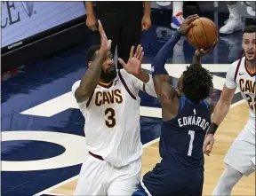  ?? JIM MONE - THE ASSOCIATED PRESS ?? The Timberwolv­es’ Anthony Edwards shoots over the Cavaliers’ Andre Drummond (3) as Larry Nance Jr. looks on Jan. 31 in Minneapoli­s.