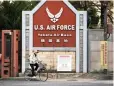  ?? PICTURE: AP ?? LEGACY OF WAR: A woman cycles past the gate of the US Yokota Air Base on the outskirts of Tokyo.