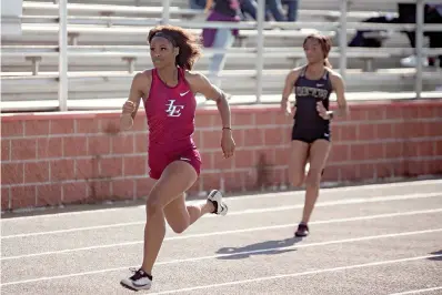  ?? Staff photo by Kelsi Brinkmeyer ?? ■ Liberty-Eylau runner Laqukeisha Jeffery competes in the 100-meter dash at a track meet hosted by Liberty-Eylau High School on Wednesday afternoon in Texarkana.