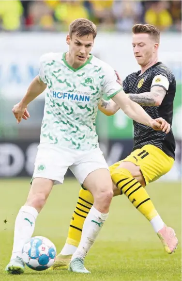  ?? Agence France-presse ?? Borussia Dortmund’s Marco Reus (right) and Fuerth’s midfielder Max Christians­en fight for the ball during their German League match on Saturday.