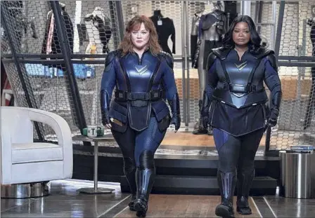  ?? Netflix ?? A displeased-looking Melissa Mccarthy and Octavia Spencer, perhaps approachin­g their "Thunder Force" writer-director Ben Falcone (Mccarthy's husband) to discuss what they think of the costumes he chose for them.