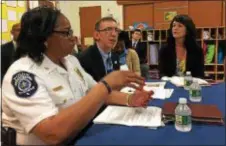  ?? KATHLEEN E. CAREY — DIGITAL FIRST MEDIA ?? Delaware County District Attorney Katayoun Copeland, right, and Darby Township Police Chief Regina Price listen to Bruce Clash of “Fight Crime: Invest in Kids” talk about early childhood education investing.
