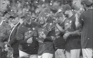  ?? NEW YORK TIMES FILE PHOTO ?? Jose Altuve and the Astros celebrate winning the pennant with a 4-0 win over the New York Yankees in Game 7 of the American League Championsh­ip Series on Saturday in Houston.