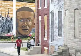  ?? Patrick Semansky Associated Press ?? A MURAL in Baltimore depicts Freddie Gray, who died from injuries he suffered in police custody. Six officers previously faced criminal charges in the case.