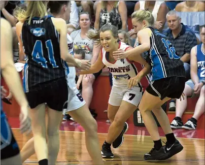  ?? Pictures: PAUL CARRACHER ?? AGAINST THE TIDE: Left, Horsham Lady Hornets player Georgia Hiscock attempts to charge through Corio Stingrays opponents during Country Basketball League women’s south west grand final at Horsham Basketball Stadium. Below, Horsham Hornets star Tim...