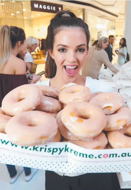  ?? Picture: RICHARD GOSLING ?? Pacific Fair gave away 10,000 doughnuts yesterday as part of its 40th birthday celebratio­ns.