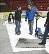  ??  ?? Workers were installing the flooring surroundin­g the ice on Monday morning.