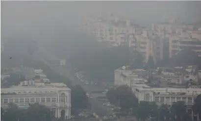  ?? AP ?? Smog envelops Connaught Place area at noon, a day after Diwali festival in New Delhi, on Friday. —