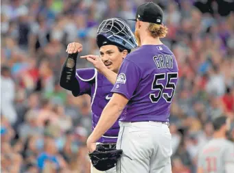  ??  ?? Rockies starting pitcher Jon Gray talks with catcher Tony Wolters on the mound last season. “He’s so hands-on about everything. It’s almost like when we’re on the mound, he’s on the mound with us,” Gray said of Wolters.