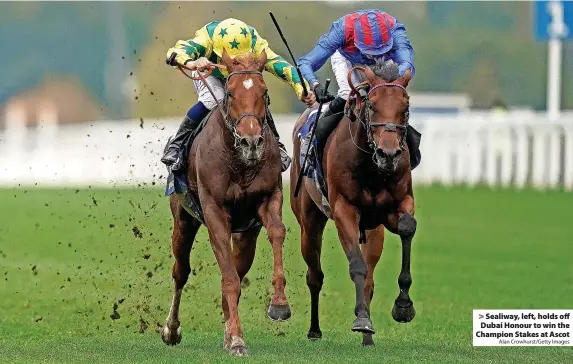  ?? Alan Crowhurst/Getty Images ?? > Sealiway, left, holds off Dubai Honour to win the Champion Stakes at Ascot