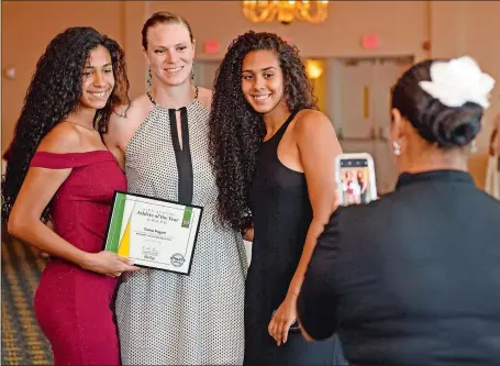  ?? SEAN D. ELLIOT/THE DAY ?? New London’s Tai Pagan, left, and her sister, India Pagan, right, pose for a photo with former Stonington great Heather Buck at the conclusion of The Day’s High School Athlete of the Year Awards banquet Wednesday at the Port ‘N Starboard banquet hall at Ocean Beach Park. Tai Pagan was the girls’ basketball player of the year for 2019, India was honored in 2017, and Buck won the honor three times.