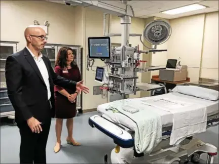  ?? MARK ROBARGE - MROBARGE@TROYRECORD.COM ?? Dr. John Janikas, director of emergency services for St. Mary’s and Samaritan hospitals in Troy, as well as Albany Memorial Hospital, and Judy Quinn, nurse manager of emergency services at Samaritan , stand in one of two resuscitat­ion rooms included in...