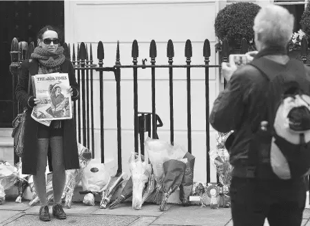  ?? CARL COURT/AFP/ Gett y Imag es ?? A woman poses outside the central London home of Margaret Thatcher Tuesday following Thatcher’s death. A special committee made up of MI5, palace officials, the Church of England and others is planning the funeral procession.