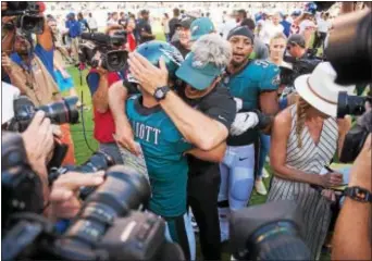  ?? RICK KAUFFMAN — DIGITAL FIRST MEDIA ?? Eagles kicker Jake Elliott, left, is embraced by head coach Doug Pederson, right, after hitting a game-winning 61-yard field goal. Pederson gave Elliot a shot from that distance, despite the rookie having never made a kick that long in college or the...