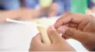  ?? EDDIE MOORE/JOURNAL ?? Helena Pena, 15, from San Ildefonso Pueblo, wraps a tamale during the “Wellness for the Mind and Body to Build Strong Communitie­s” program in July for youths from New Mexico Pueblos.