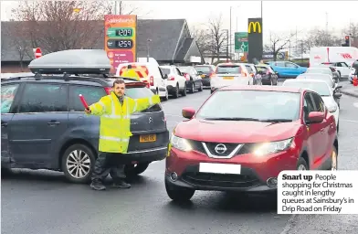  ??  ?? Snarl up People shopping for Christmas caught in lengthy queues at Sainsbury’s in Drip Road on Friday