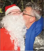  ??  ?? Santa gets a Christmas kiss from Pat Kent.