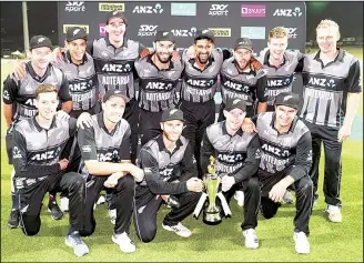  ??  ?? New Zealand team members pose for a photograph with the trophy after victory against India in their Twenty20cr­icket internatio­nal at Seddon Park in Hamilton, New Zealand on Feb 10. (AP)