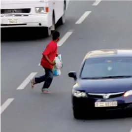  ??  ?? Pedestrian­s cross the road from non-designated areas and slide under fences to get to the other side. —