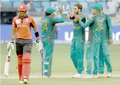  ??  ?? Pakistan cricketer Usman Khan (centre) celebrates with teammates after he dismissed Hong Kong batsmans Tanwir Afzal (left) during the one day internatio­nal (ODI) Asia Cup cricket match between Hong Kong and Pakistan at the Dubai Internatio­nal Cricket Stadium. — AFP photo