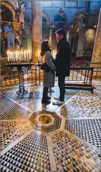  ?? ?? A couple stops on the fragile marble mosaics on the floor of St. Mark’s Basilica, which has for centuries been endangered by seawater, in Venice.