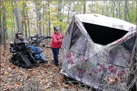  ?? NWA Democrat-Gazette/FLIP PUTTHOFF ?? Jackie helps Steve into his hunting blind in 2016. The buck Swope killed in September this year walked within 5 feet of the blind before he took it with a 30-yard crossbow shot.