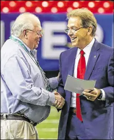  ?? BUTCH DILL / ASSOCIATED PRESS ?? Broadcaste­r Verne Lundquist (left) greets Alabama coach Nick Saban at practice. Saturday’s championsh­ip game was the last for Lundquist as the play-by-play voice of SEC football on CBS.