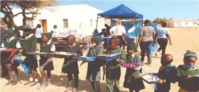  ?? ?? Schoolchil­dren from Kungubo Primary School in Plumtree show off gifts donated to them by female commercial pilot Precious Sibalo