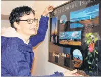  ?? MILLICENT MCKAY/JOURNAL PIONEER ?? Kensington and Area Refugee Sponsorshi­p Initiative member, Lianne Murray, hangs a photo of Island images on the wall in the house that a Syrian family will move into in the coming weeks.