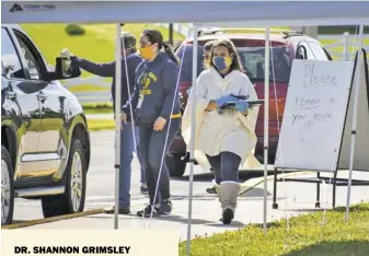  ?? BY HOLLY JENKINS ?? April 15: RCPS Superinten­dent
Dr. Shannon Grimsley helps distribute laptops to students in need.