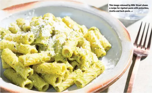 ?? AP ?? This image released by Milk Street shows a recipe for rigatoni pasta with pistachios, ricotta and herb pesto.
