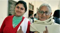  ?? PTI ?? Two voters showing their inked fingers after casting their votes in Dharampur constituen­cy in Dehradun, Uttarakhan­d. —