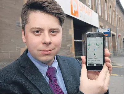  ?? Picture: Phil Hannah. ?? Stewart Digney showing the app outside the Kinnoull Street car park in Perth.