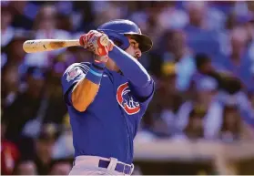  ?? Gregory Bull / Associated Press ?? The Cubs’ Alfonso Rivas connects for a two-run single in the eighth inning in San Diego. The hit snapped a 5-5 tie.