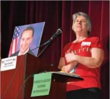  ?? MARIAN DENNIS – DIGITAL FIRST MEDIA ?? Tammy Harkness, an organizer of Saturday’s town hall meeting, stands next to a photo of U.S. Rep. Ryan Costello, R-6, who was invited to the meeting but could not attend because of scheduling conflicts.