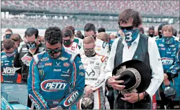  ?? JOHN BAZEMORE/AP ?? Bubba Wallace, left, with team owner Richard Petty, is the only Black driver in the Cup Series.
— Rev. Greg Drumwright, who has organized members of his ministry to make trips to NASCAR races and support Bubba Wallace