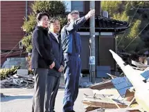  ?? Japan News ?? Japan’s emperor (center) and empress (left) listen to an explanatio­n by Noto Mayor Kazuyo Omori (right), about the tsunami damage by the Noto Peninsula Earthquake in Noto, Ishikawa Prefecture, April 12.