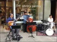  ?? SARATOGA COUNTY CHAMBER OF COMMERCE PHOTO ?? A trio performs jazz music in front of Broadway shop The Savory Pantry for the inaugural Jazz Fest Friday in 2018.