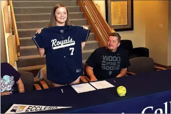  ?? COURTESY PHOTO ?? Lincoln’s Ashtyn Rothrock holds up an Ecclesia College Royals jersey as her father, James Rothrock, looks on. Rothrock signed with the college in Springdale on June 13.