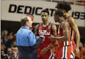  ?? MITCH ALCALA — THE ASSOCIATED PRESS, FILE ?? Mississipp­i head coach Kermit Davis, left, talks with players against Oklahoma State on Jan. 28in Stillwater, Okla. Davis and the school “have mutually agreed to part ways effective immediatel­y.”