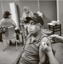  ?? Jon Shapley / Staff photograph­er ?? Manuel Gaitan, a Vietnam veteran, gets vaccinated Saturday at the Michael E. DeBakey VA Medical Center in Houston.