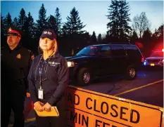  ??  ?? Captain Beverley Harvey, of the Transporta­tion Safety Board of Canada, addresses reporters Sunday evening after a plane crash that forced the closure of a section of McGee Side Road.