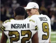  ?? BILL FEIG — THE ASSOCIATED PRESS ?? New Orleans Saints quarterbac­k Drew Brees (9) talks with running back Mark Ingram (22) in the second half of an NFL football game against the Philadelph­ia Eagles in New Orleans Sunday.