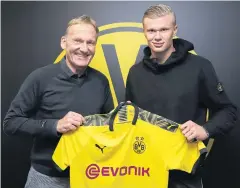  ?? AFP ?? Dortmund’s new recruit Erling Braut Haaland, right, poses with the club’s CEO Hans-Joachim Watzkem.